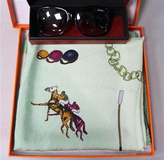 A pair of Cartier sunglasses and a Hermes scarf